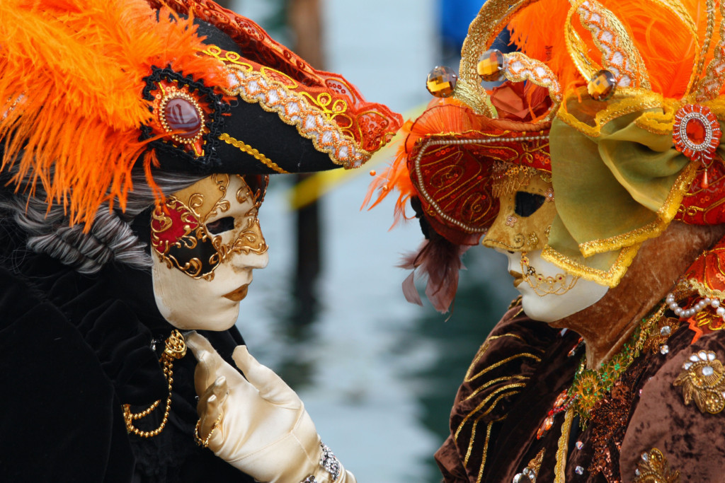 A masked and gloved couple in love at the 2010 Carnival of Venice. By Frank Kovalchek (CC BY 2.0) via Wikipedia. https://en.wikipedia.org/wiki/Carnival_of_Venice#/media/File:Venice_Carnival_-_Masked_Lovers_(2010).jpg