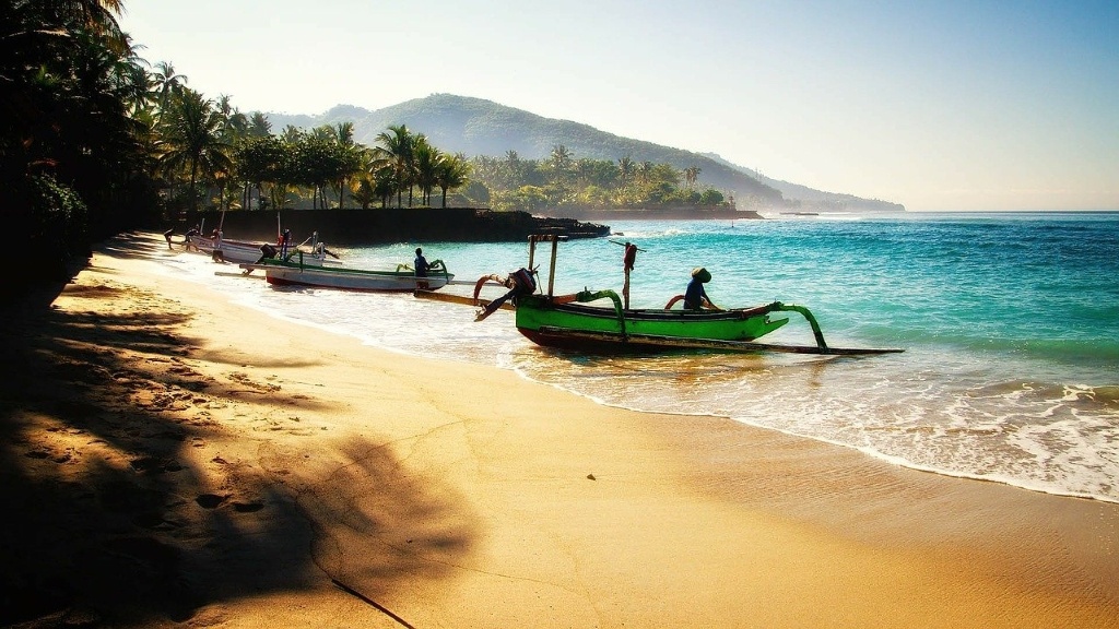 Boats and beach. Bali, Indonesia. By keulefm (CC0) via Pixabay. https://pixabay.com/photos/bali-beach-travel-boats-vacations-237196/