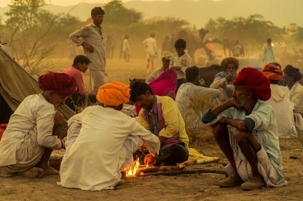 We tell stories around campfires at home gatherings even to ourselves when we are alone. Photo from the annual camel fair in Pushkar India by Siddharth Singh CC0 via Unsplash.