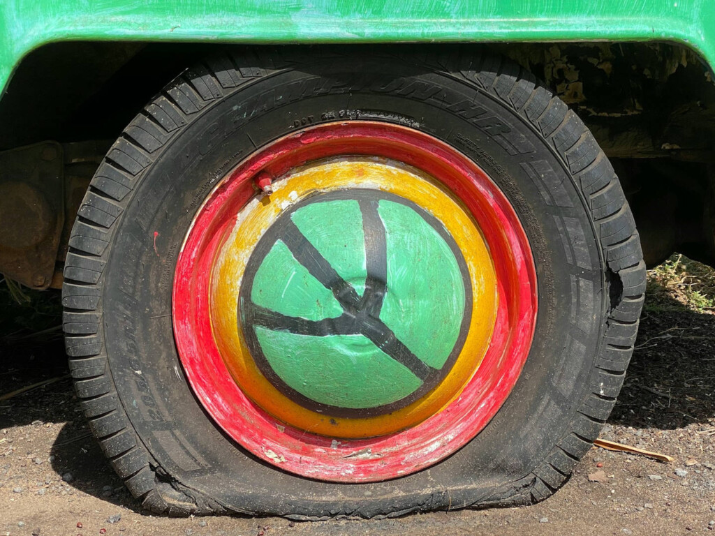 Travellers, tourists, and tourism for peace ... Picture of flat tyre with peace sign hub cap by Charles Pickrell (CC0) via Unsplash.