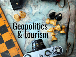 Geopolitics and tourism. Image by StarFlames (CC0) via Pixabay. https://pixabay.com/photos/chess-camera-world-map-2258804/ "GT" cropped it and added the words "Geopolitics & tourism".